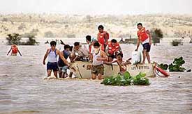 Volunteers and Army men carry out a body recovery operation in Barmer district of Rajasthan on Wednesday following floods that claimed at least 150 lives in the past week. 