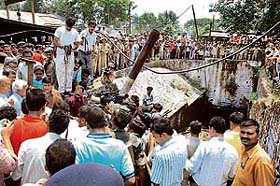 A crowd gathers outside the 17th seam of Mahuda Mines of BCCL at Dhanbad in Jharkhand on Thursday where over 50 miners were trapped underground after an explosion