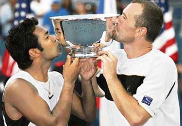 Leander Paes and his doubles partner Martin Damm of the Czech Republic kiss their trophy after winning the men's doubles final