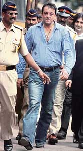 Bollywood star Sanjay Dutt, surrounded by police officers, leaves after appearing in a TADA court in Mumbai on Tuesday. 
