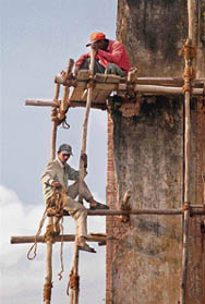 Construction workers prepare scaffolding on a soon-to-be renovated building in New Delhi. Though India’s $775 billion economy expanded 9.3 per cent from a year earlier, yet the urban housing shortfall in India is being calculated at some 7.6 million units, of which approximately three quarters represent replacement and upgrading needs, with sharing of a dwelling accounting for the balance.