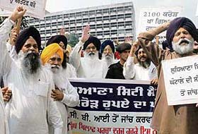 SAD and BJP MLAs protest outside the Punjab Vidhan Sabha against the alleged Ludhiana City Centre scam in Chandigarh