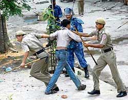 The police arrests a demonstrator while trying to disperse a mob which got violent during a protest against the sealing drive launched by the Delhi civic authorities at Seelampur in East Delhi on Wednesday. 