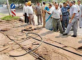 UT Administrator S.F. Rodrigues inspects the concrete road being laid on the road dividing sectors 31 and 32 in Chandigarh on Friday.