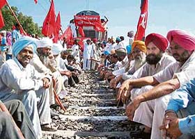 Activists of the Punjab Kisan Sabha stop a train as part of their rail roko agitation at Rajpura