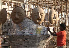 An artisan prepares effigies of Ravana and his brothers for Dasehra
