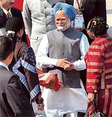 Prime Minister Manmohan Singh is received by South African officials on his arrival at Durban airport in South Africa