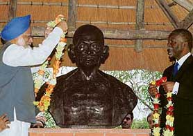 Prime Minister Manmohan Singh and South African President Thabo Mbeki garland a bust of Mahatma Gandhi at the Phoenix Gandhi Settlement, Durban, in South Africa on Sunday.