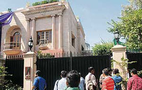 Mediapersons wait outside the residence of Suresh Nanda on Prithviraj Road, where the CBI conducted raids in connection with defence deals, in New Delhi on Tuesday.
