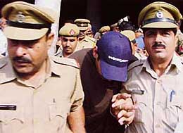 Punjabi singer Gursewak Mann is led out of the district court complex by the police in Sector 1, Panchkula, on Tuesday.