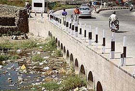 Stagnant water and polythene bags on the bed of the Sukhna choe pose a serious health hazard to scores of city residents