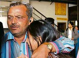 A passenger of the detained Delhi bound Air-India flight is hugged by her relative after her arrival at IGI Airport in New Delhi on Sunday. The aircraft was grounded after it was hit by a bird while taking off at London's Heathrow Airport.