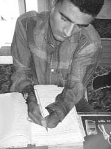 Noor Mohammad of Ratoli village in Yamunanagar uses both his hands to write.