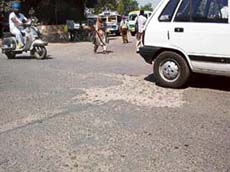 A road dotted with potholes in Kapurthala.