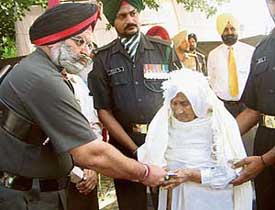 Param Vir Chakra winner Subedar Joginder Singh’s widow, Gurdial Kaur, being honoured at memorial function organised by the Army in Moga on Monday.