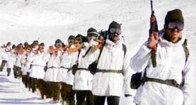 Infantrymen patrol the snow-bound area along the Line of Control (LoC) in the northern sector
