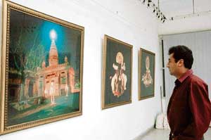 FACE TO FACE: Yann Toma views his digital art at the Alliance Francaise de Chandigarh.