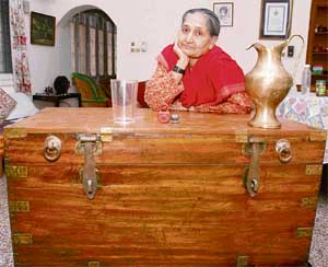 Billa Brar with her antique chest and milk jar