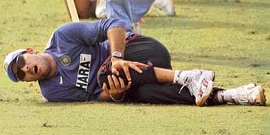 Yuvraj Singh grimaces in pain after he was injured during a training session for the ICC Champions Trophy at the PCA Stadium in Mohali on Saturday. 