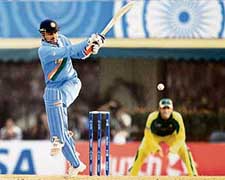 Virender Sehwag keeps his eyes on the ball after playing a stroke during a match for the ICC Champions Trophy tournament between India and Australia at the PCA stadium in Mohali on Sunday