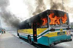 A DTC bus is set on fire by protesting traders near Mother Dairy in East Delhi during the last day of the Delhi bandh