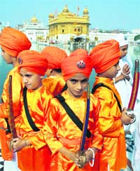 Children dressed as Panj Piaras in the Golden Temple parkarma during the nagar kirtan procession held on the eve of the birth anniversary of Guru Nanak Dev