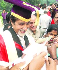 Amitabh Bachchan signs autographs for staff members of Delhi University after an honorary doctorate was conferred on him by the university in New Delhi