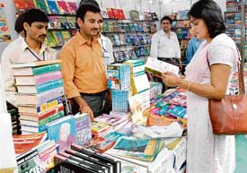 A woman browsing through a book at a stall put up at the book fair in Sector 34 on Friday