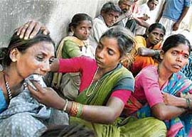 A woman consoles an aggrieved relative of the victim of the Carter Road car accident, in Bandra, Mumbai