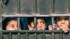 Children look at the sealing operation conducted by the civic authorities at Greater Kailash in South Delhi on Monday. 
