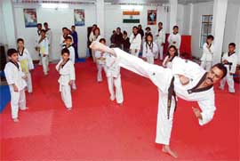 Vinod Kumar, a black belt, has made taekwondo a popular sport in the hill state