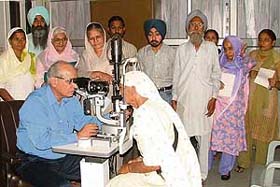 A doctor examines the eyes of a patient at a camp organised by SNS Pahwa Charitable Hospital in Ludhiana