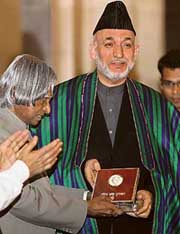 President A.P.J. Abdul Kalam presents the Indira Gandhi Prize for Peace, Disarmament and Development to Afghanistan President Hamid Karzai during a ceremony at Rashtrapati Bhavan in New Delhi on Sunday. 