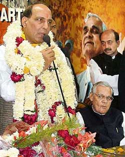 Newly elected BJP President Rajnath Singh with senior leader Atal Bihari Vajpayee addresses a meeting at the BJP headquarters in New Delhi on Sunday