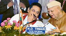 Sri Lanka President Mahinda Rajapakse discusses a point with Uttaranchal Chief Minister N D Tiwari during a meeting of Asian Mayors in Dehra Dun on Sunday