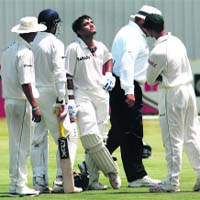 Sourav Ganguly reacts after being hit on the head by a bouncer from South Africas Mornantau Hayward on day one of a four-day tour match against the Rest of South Africa