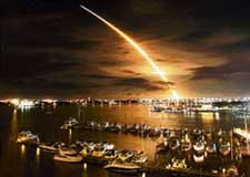 The Space Shuttle Discovery streaks across the sky over Daytona Beach, Florida, after lift-off from Kennedy Space Center on Saturday
