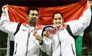 Leander Paes and Sania Mirza celebrate with their gold medals after winning mixed doubles final at the Asian Games on Wednesday