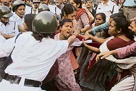 Activists from the Socialist Unity Centre of India (SUCI) scuffle with the police during a protest in Kolkata