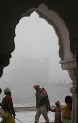 Undeterred on a cold and foggy morning devotees pay obeisance at Harmandar Sahib in Amritsar