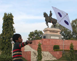 A boy flies a kite at the historical Rmmbagh in Amritsar