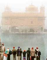 As the temperature touched zero, dense fog enveloped the Golden Temple on Wednesday