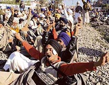 Farmers block trains on the Amritsar-Delhi route in protest against the anti-farmer policies of the state government in Amritsar on Thursday.