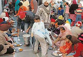 Devotees partake langar on the occasion of Gurpurb at Sector 8 gurdwara in Chandigarh