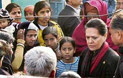 Congress president Sonia Gandhi talks to kin of the victims of Nithari serial killings, at Nithari village, Noida, UP, on Saturday. 