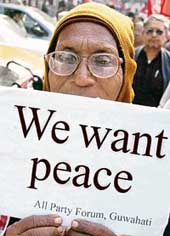 An activist from a political party holds a placard during a peace rally in Guwahati on Monday. 