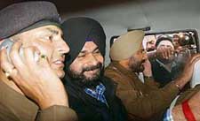 Navjot Singh Sidhu in police jeep outside the Central Jail in Patiala after his surrender in a Chandigarh court on Thursday