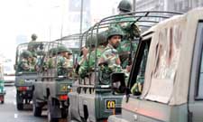 Soldiers patrol a street ahead of upcoming elections in Dhaka on Thursday