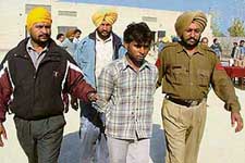 Mukesh Kumar being led away