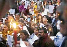 Parents of missing children and social activists participate in a candlelight march at Jantar Mantar in New Delhi on Sunday evening